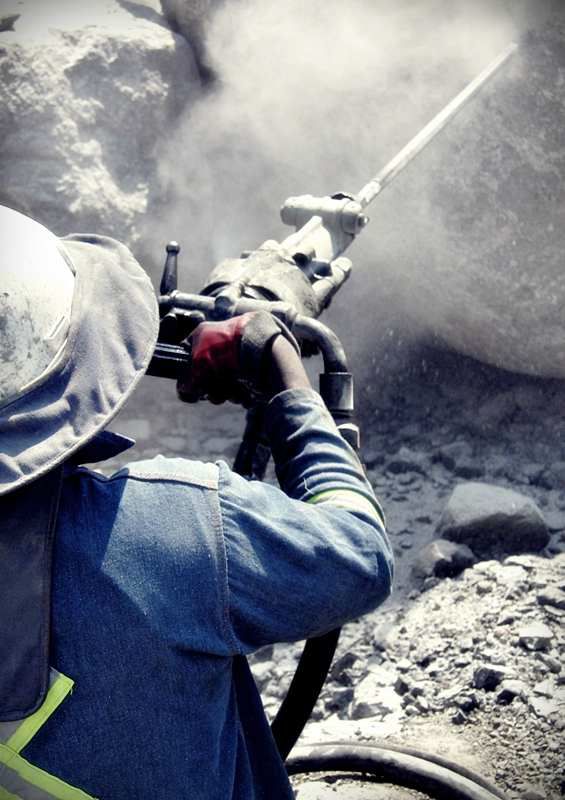 Worker applying shotcrete underground
